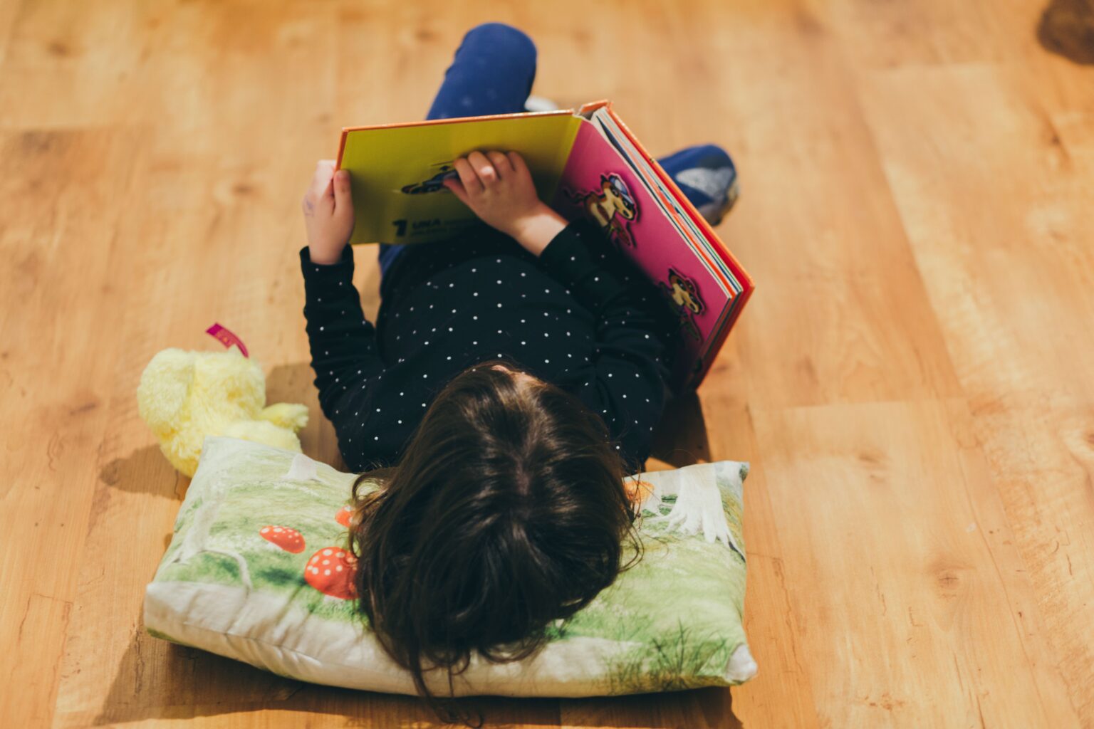 unrecognizable-girl-reading-toy-book